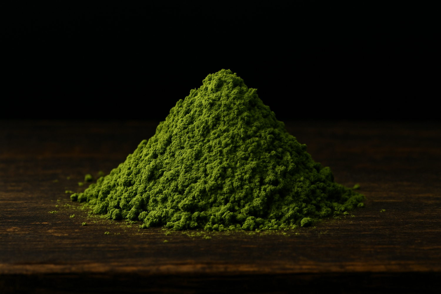 Pile of green powder on a wooden surface with a dark background